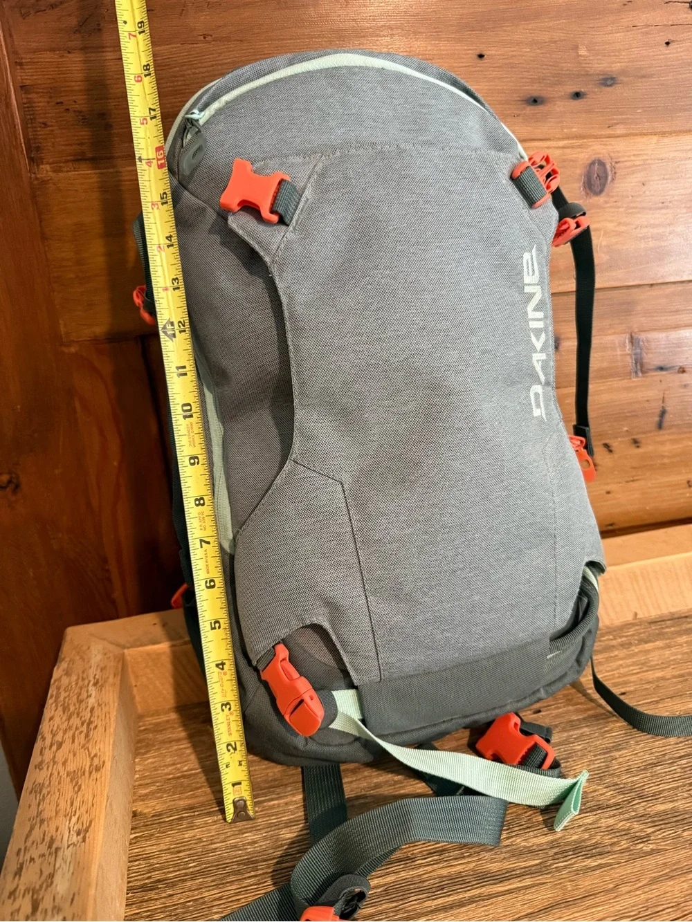 Dakine Mint tinted heli pack 12 backpack with Orange Buckles